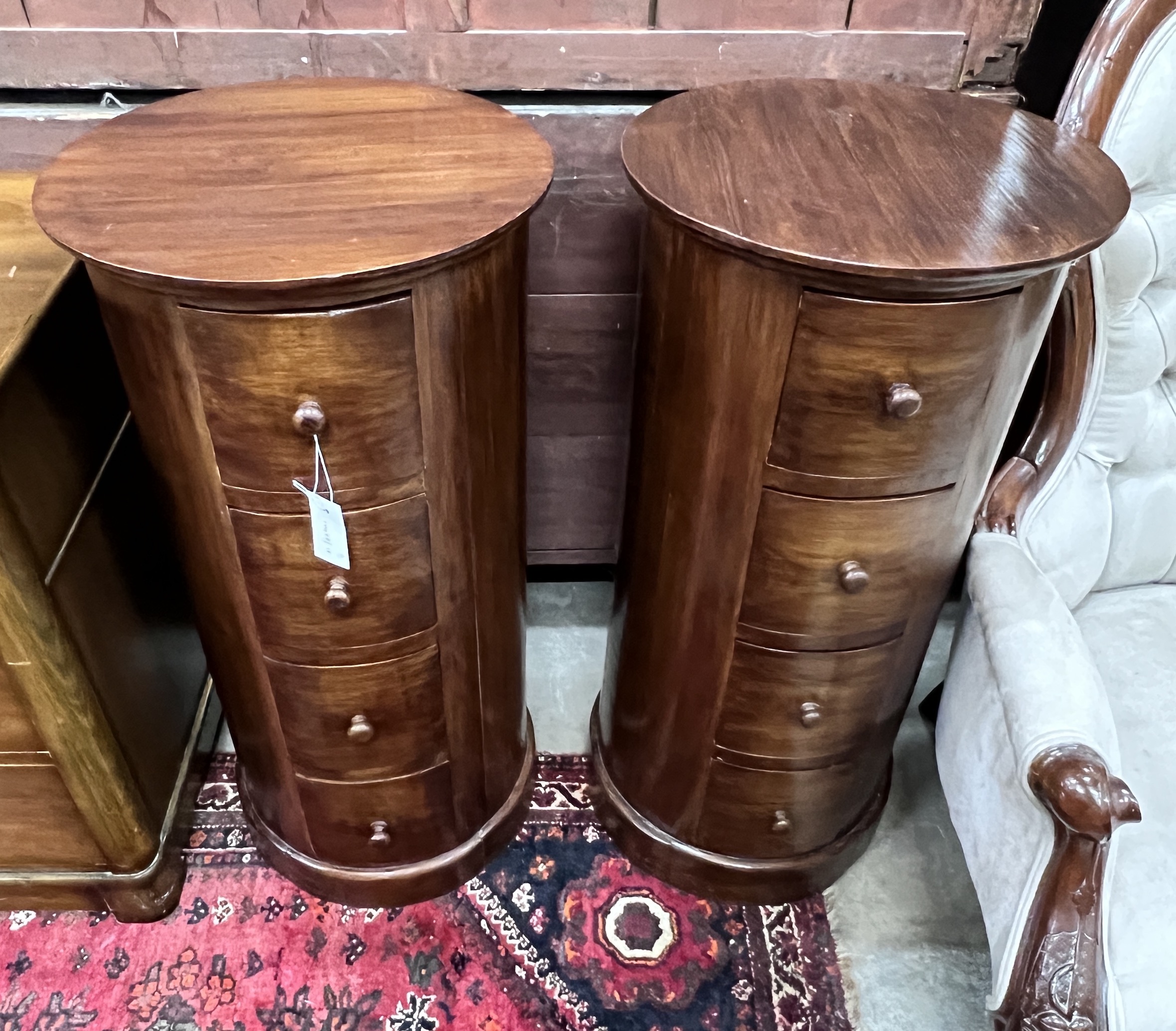 A pair of reproduction mahogany cylindrical bedside cupboards, each fitted four small drawers, diameter 41cm, height 85cm